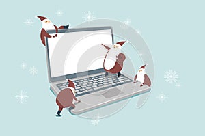 Funny little Santas over digital laptop computer Online shopping forÂ  Christmas and New YearÂ concept. Santa Gnomes cartoon